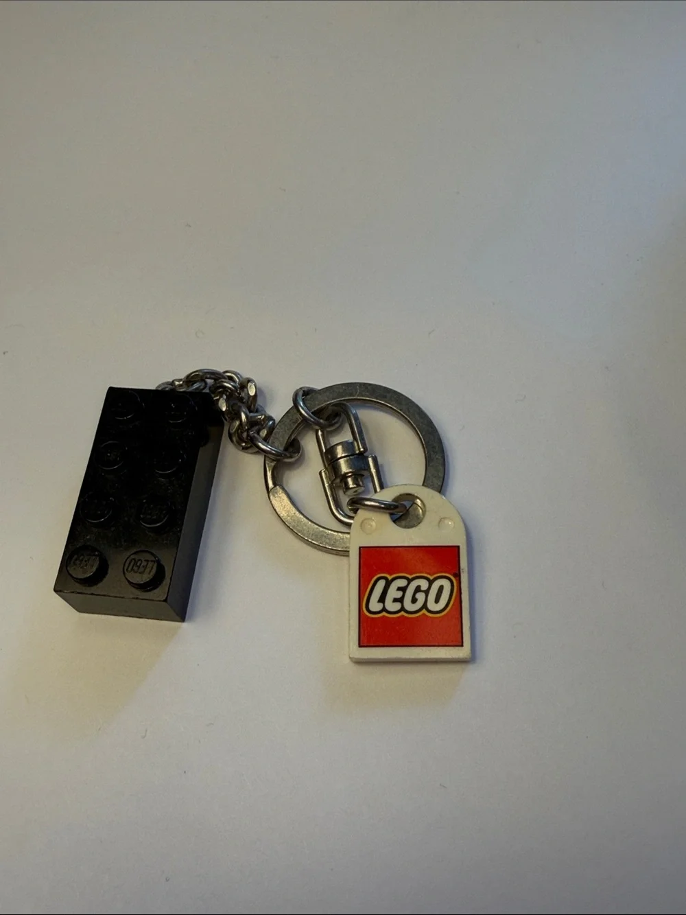 Lego Black Brick Keychain with White and Red Logo Tag